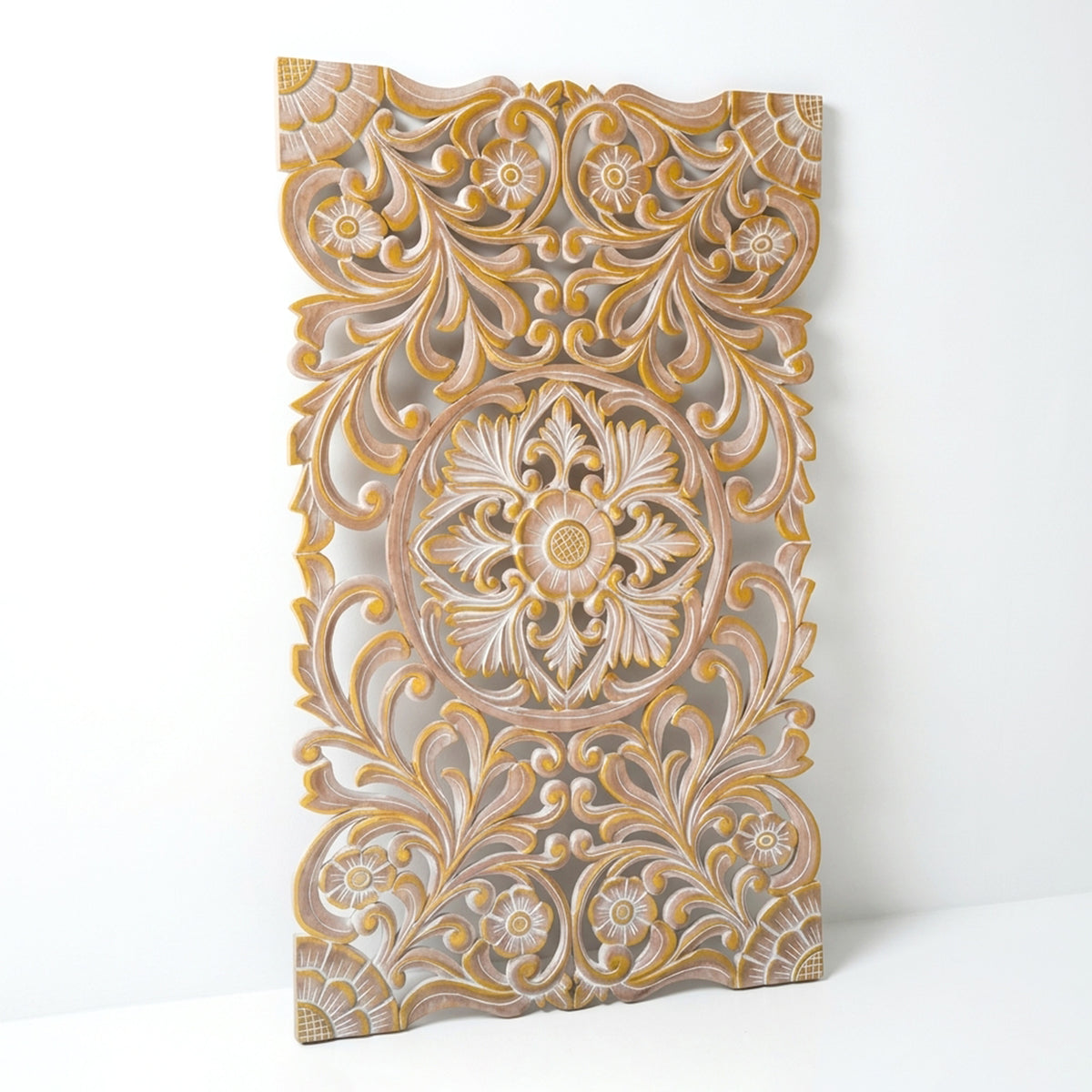 An ornate rectangular carved wooden wall panel with intricate floral and scroll motifs, shown standing against a plain white background.